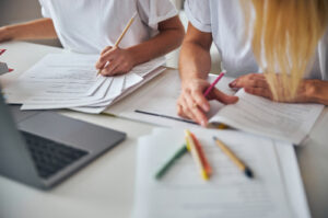 Cropped,Photo,Of,Females,Working,Together,With,Studying,Materials,While